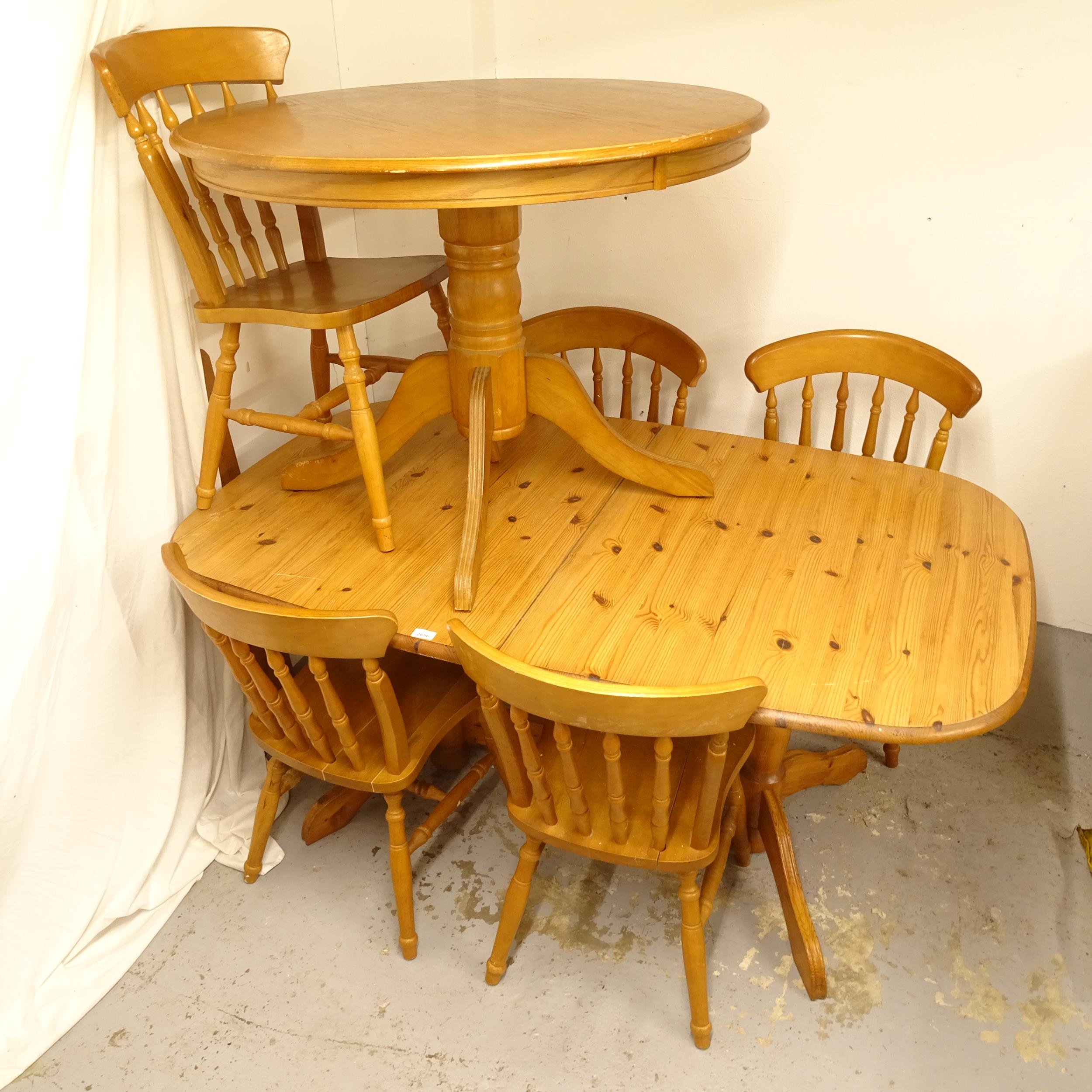 A pine extending dining table with single spare leaf, together with a set of 5 matching chairs,