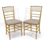 A pair of gilt faux bamboo chairs