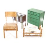 A small green painted 5-drawer chest, a child's bent-ply chair, a doll's cooking range, and faux