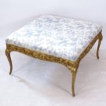 A large Continental style giltwood stool, re upholstered with Anne Sloan Linen, with applied