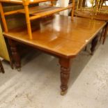 A late Victorian walnut canted-cornered wind-out dining table, on baluster turned legs, L150cm,