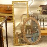A modern walnut-effect display cabinet, 2 wall clocks, a gilt-framed mirror, and another