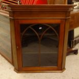 An Antique mahogany satinwood-strung hanging corner cabinet, with arch-top glazed door, W76cm, H83cm