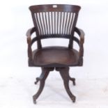 E W Godwin for James Peddle, a Victorian oak Aesthetic swivel desk chair