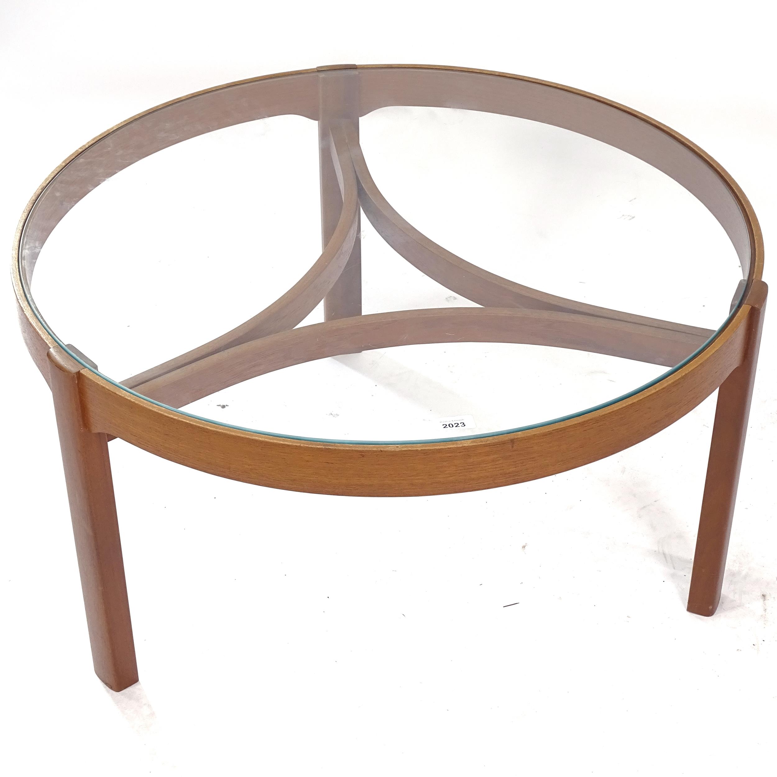 A mid-century circular glass-top teak coffee table, W82cm
