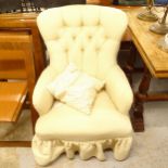 An Edwardian button-back upholstered armchair