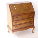 A 1930s crossbanded figured walnut 3-drawer bureau, W80cm, H101cm, D48cm