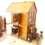 A Vintage handmade doll's house, complete with a large quantity of furniture, including a mid-