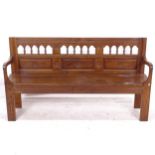 A 19th century oak hall bench, with a spindle and carved panelled raised back, L160cm, H90cm, D38cm,