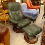 An Ekornes leather-upholstered swivel reclining armchair, and matching footstool