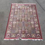 A red ground handmade and hand knotted pure wool Kashmiri carpet, with Tree of Life pattern, 275cm x
