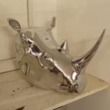 A polished silvered metal rhinoceros-head wall hanging