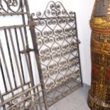 A decorative scrolled wrought-iron side gate, width including hinge mount 91cm, H152cm