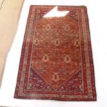 A red ground Persian Heriz rug, 207cm x 138cm