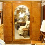 A French Art Deco burr-walnut bow-end armoire, with a central arch-top mirror door, L178cm,