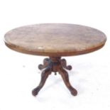 A Victorian burr-walnut oval loo table, on a carved sabre leg base, W120cm, H72cm