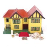 A Vintage handmade doll's house with furniture, W78cm, H47cm, D42cm