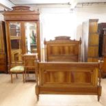 An Antique French walnut bedroom suite, comprising a mirrored 2-door armoire, a 4'6" carved and