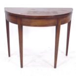 A Georgian mahogany fold over tea table of bow-front form, on tapered legs, W91cm, H72cm
