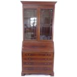 A reproduction bureau bookcase with fitted interior, W92cm, H210cm, D42cm