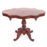 A hardwood centre table of shaped form, on a turned centre column and sabre leg base, W116cm, H80cm,