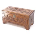 A small Oriental relief carved camphorwood chest, W73cm, H37cm, D35cm