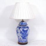A Chinese blue and white porcelain table lamp on wooden base, height to top of jar 44cm