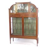 A late Victorian mahogany display cabinet of arch-top form, satinwood banded, astrocal glazed doors,