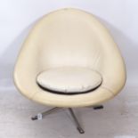 A mid-century cream rexine-upholstered swivel lounge chair, on metal base