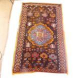 An orange ground wool Persian design rug, 196cm x 125cm