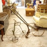 An ornamental wrought-iron penny-farthing, H59cm, and a small iron plough