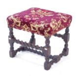 An 18th century oak upholstered footstool