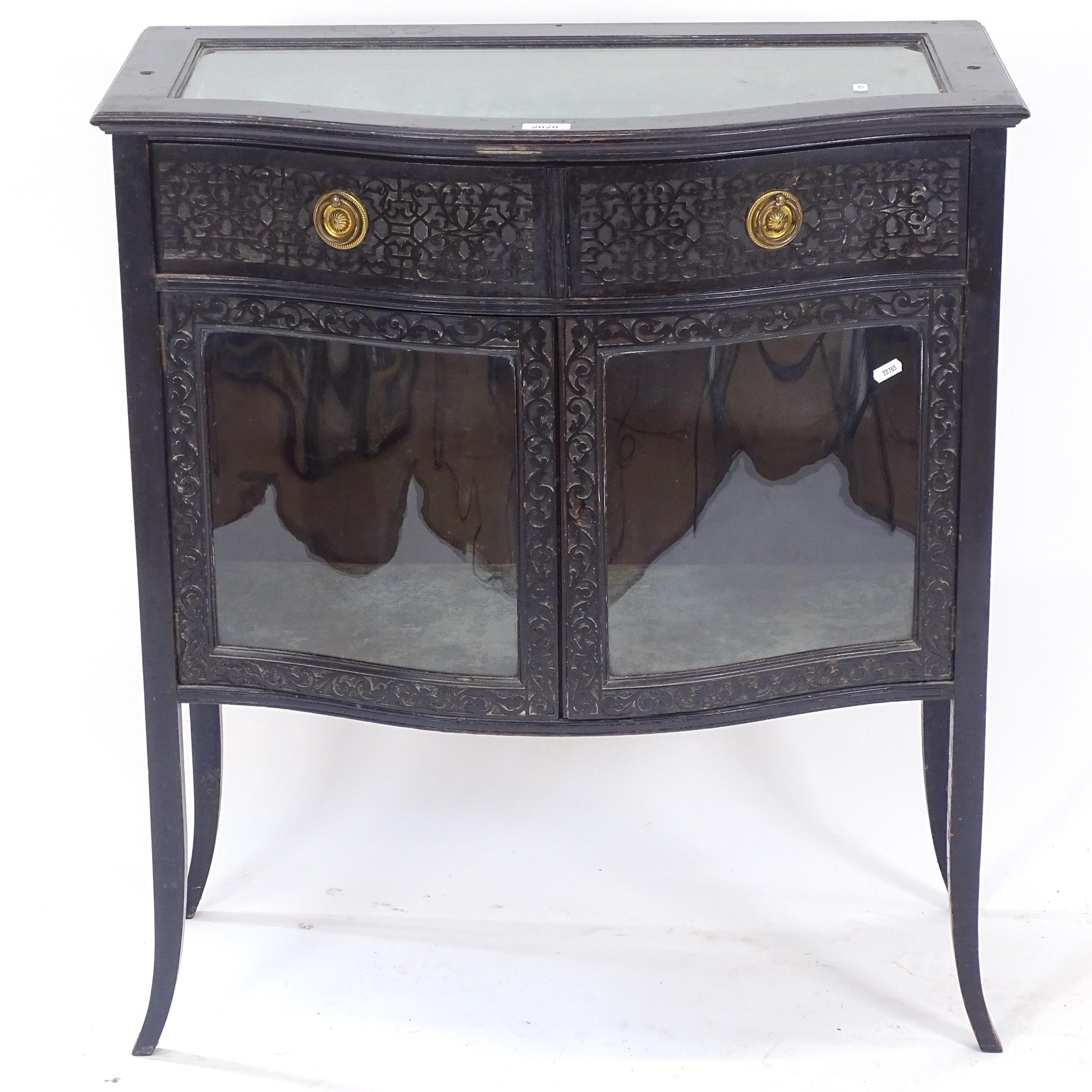 An ebonised vitrine display cabinet of serpentine form, W78cm, H88cm, D41cm