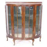 A 1930s walnut serpentine-front display cabinet, W103cm, H116cm, D38cm