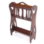 An early 20th century oak magazine/book rack of stylised form, W53cm, H77cm