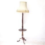 An Edwardian mahogany standard lamp and shade, with integral shelf, on tripod base, overall height