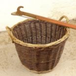 A wicker 2-handled basket, and a long-reach lopper