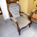 A Victorian walnut-framed open armchair, with button-back upholstery