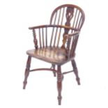A mid 19th century yew wood bow back Windsor armchair with elm seat