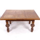 A large rectangular oak draw leaf dining table, on baluster carved legs, L152cm extending to