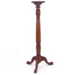 A mahogany fluted torcher stand, on carved tripod base, W27cm, H129cm