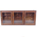 An Antique mahogany display cabinet, with 3 glazed doors, W139cm, H60cm, D15cm (1 shelf missing)