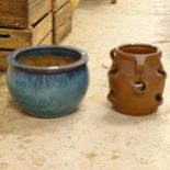 A blue glazed terracotta garden pot, and a treacle-glazed strawberry pot