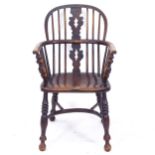 An Antique elm bow-arm Windsor armchair with crinoline stretcher