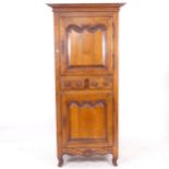 A Continental fruitwood hall cupboard, with 2 fielded panelled doors, and 2 central short drawers,