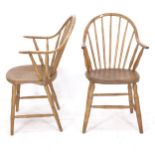 A pair of elm-seated stick-back elbow chairs