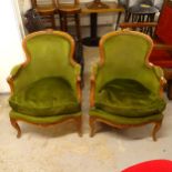 A pair of Continental carved beech-framed upholstered armchairs