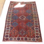 An Antique red ground Caucasian rug, 200cm x 146cm