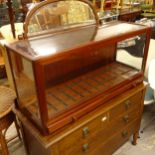 An early 20th century Flashman teak-cased shop display cabinet, with drawer to the base, W105cm,