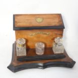 A deskstand with painted and inlaid brass mounts, with 2 cut-glass inkwells, and another glass